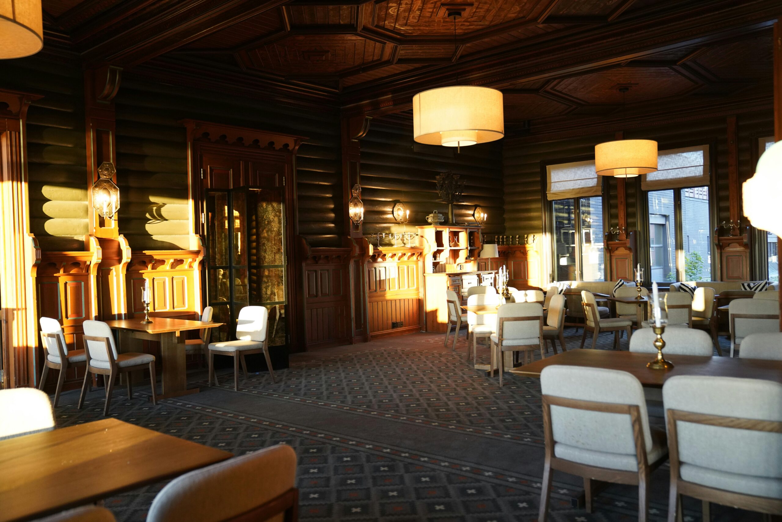 A warm and inviting vintage dining room with wooden decor and elegant lighting.